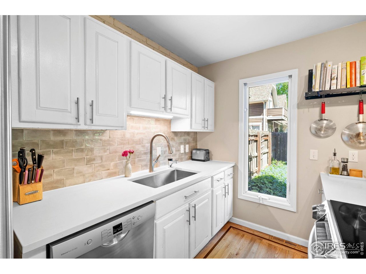 3878 Broadway, Unit 1 Boulder, CO 80304 - Photo 9 of 36 a kitchen with a sink cabinets and a window