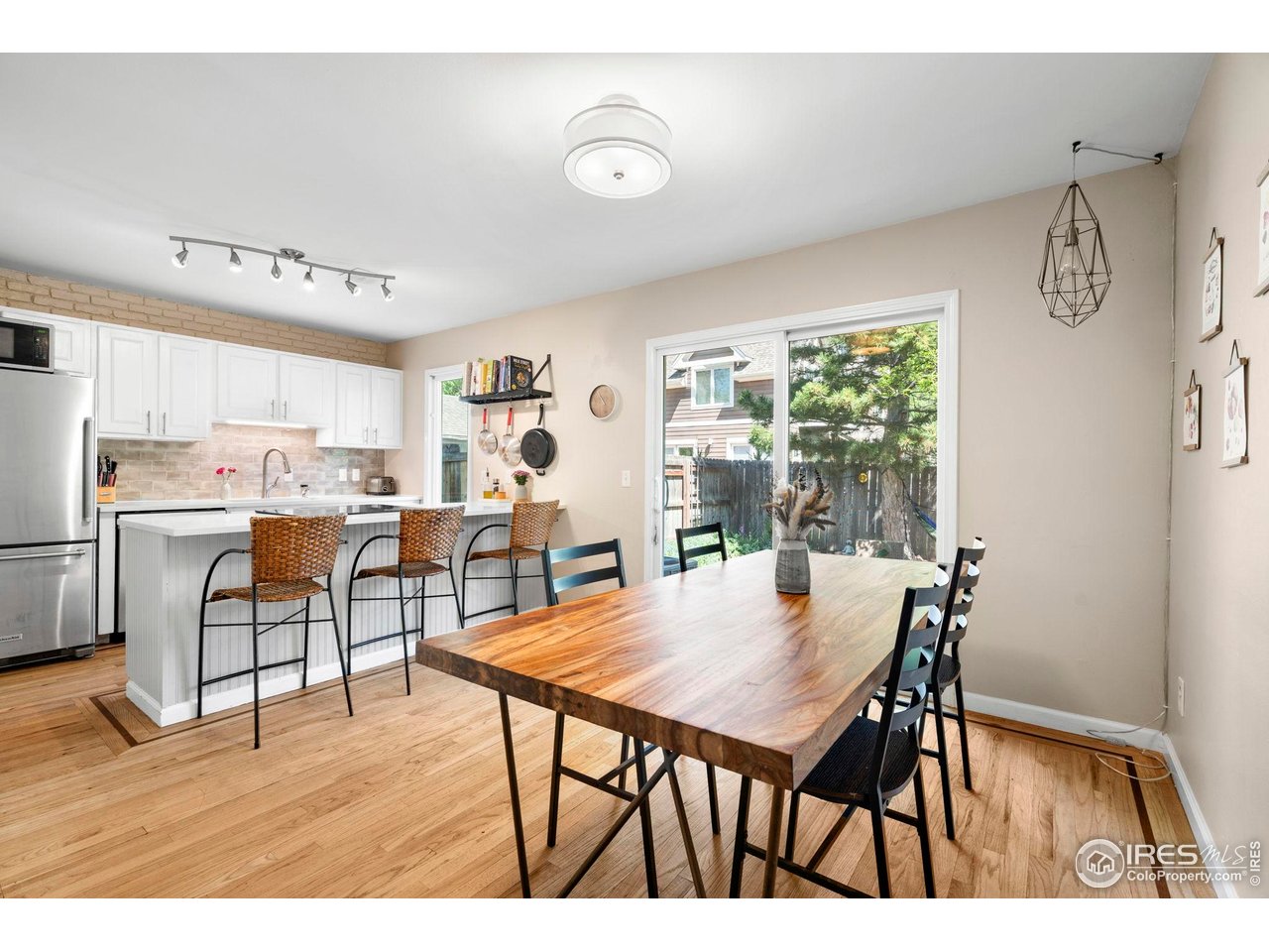 3878 Broadway, Unit 1 Boulder, CO 80304 - Photo 10 of 36 a view of a dining room with furniture and wooden floor