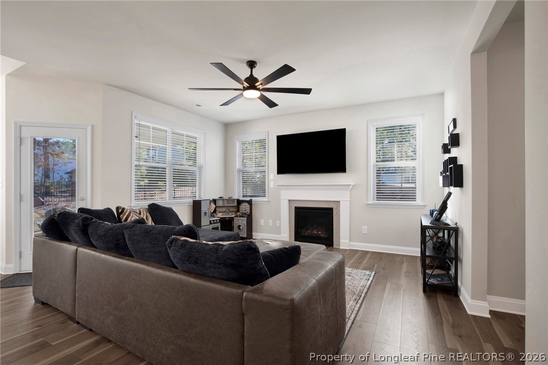 224 Timber Skip Drive Spring Lake, NC 28390 - Photo 7 of 30 a living room with furniture a fireplace and a flat screen tv