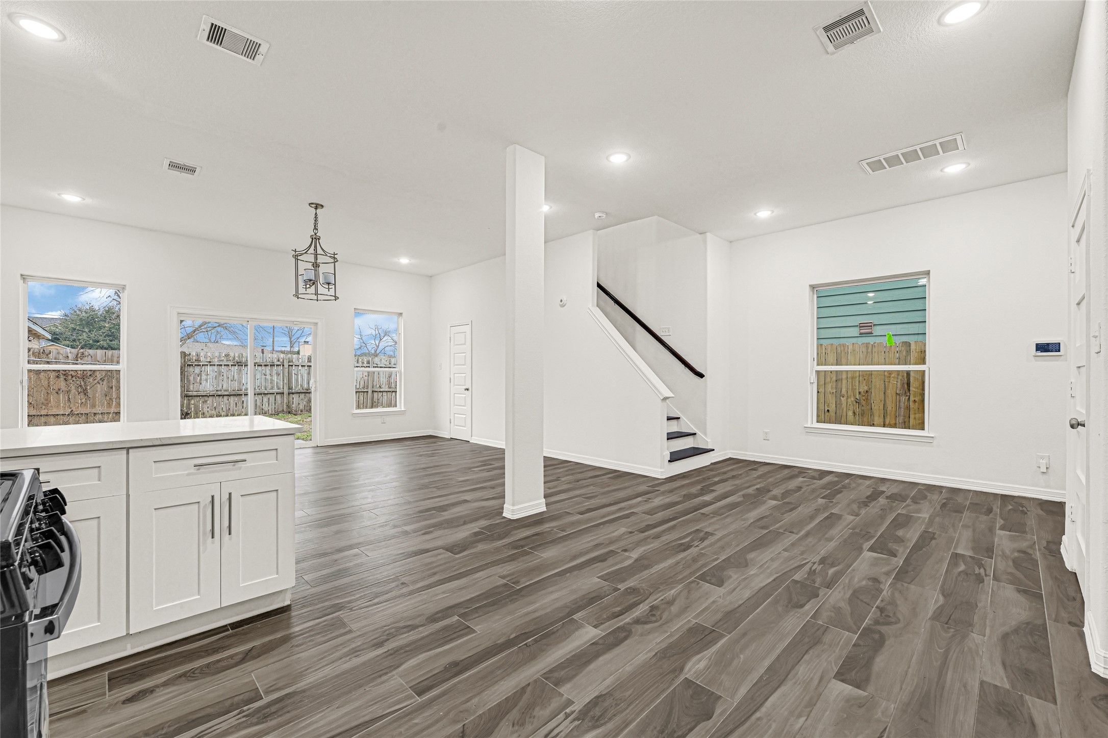 8628 Scott Street Houston, TX 77051 - Photo 4 of 22 a view of an empty room with wooden floor and windows