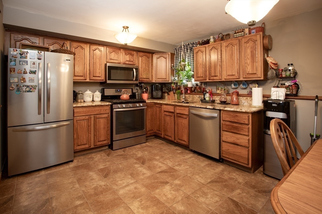 166 Stonehaven Road Fall River, MA 02723 - Photo 21 of 33 a kitchen with stainless steel appliances granite countertop a refrigerator sink and cabinets