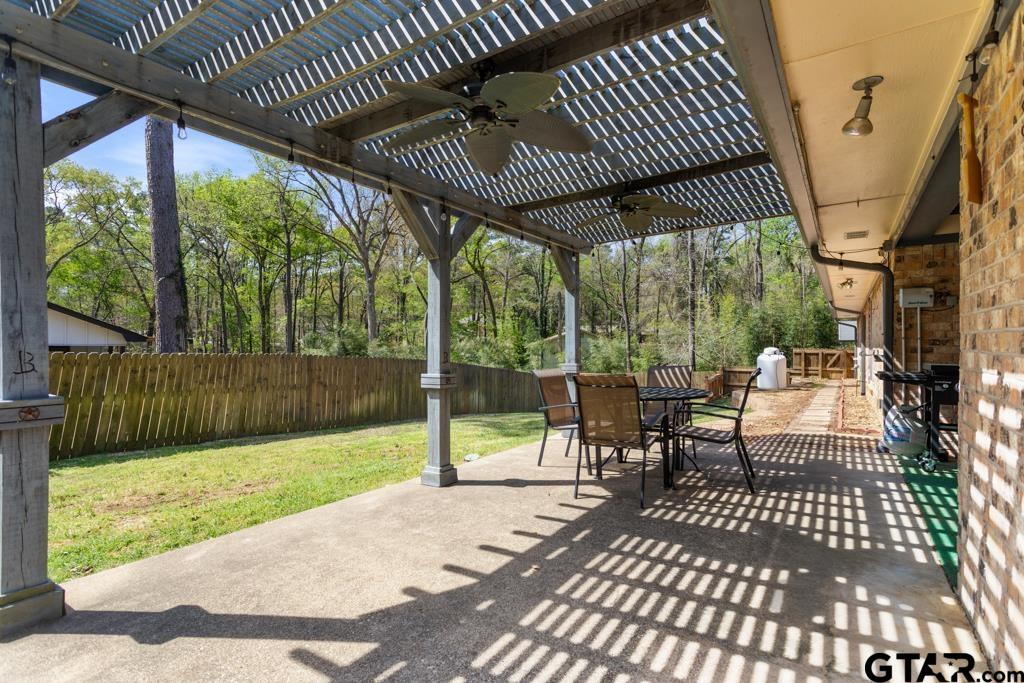 1302 Lake Cross Road Hideaway, TX 75771 - Photo 22 of 31 a view of a porch with wooden floor table and chairs