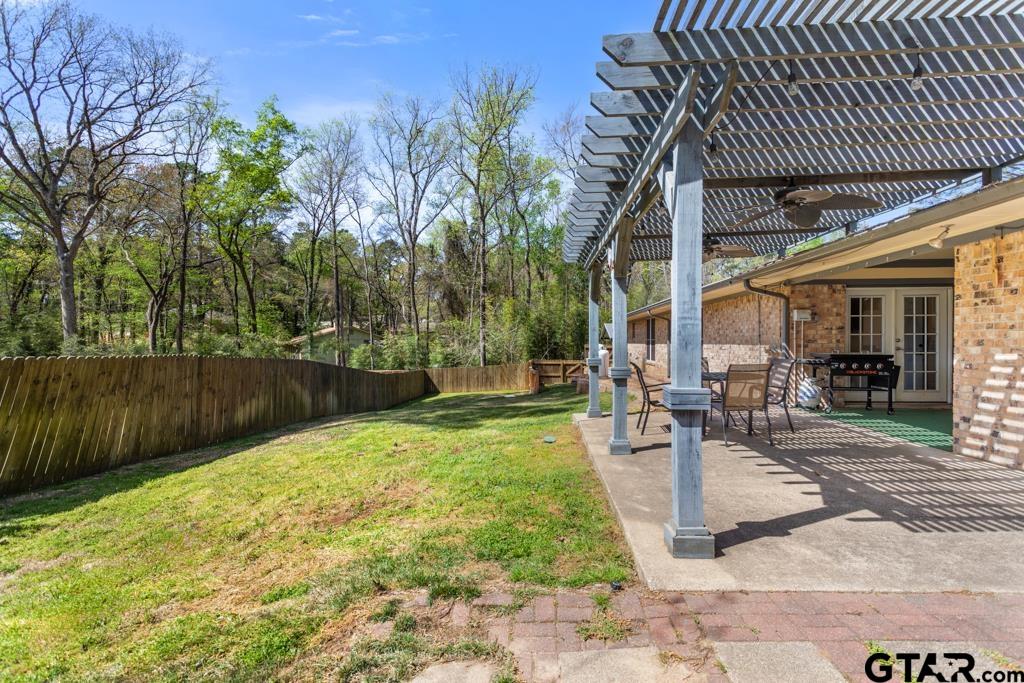 1302 Lake Cross Road Hideaway, TX 75771 - Photo 23 of 31 a view of a backyard with sitting area