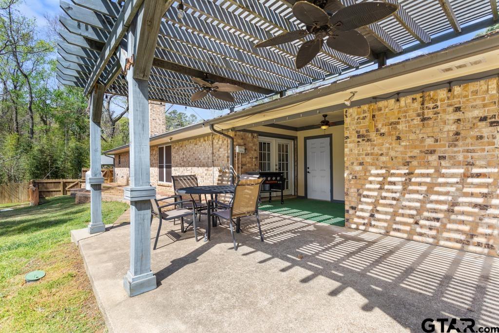 1302 Lake Cross Road Hideaway, TX 75771 - Photo 24 of 31 a view of a patio with a table and chairs and potted plants