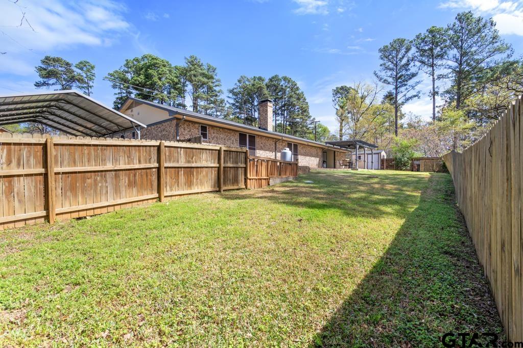 1302 Lake Cross Road Hideaway, TX 75771 - Photo 25 of 31 a view of a house with a backyard and a garden