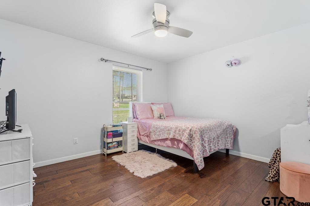 1302 Lake Cross Road Hideaway, TX 75771 - Photo 29 of 31 a bedroom with a bed and a flat tv screen on the dresser