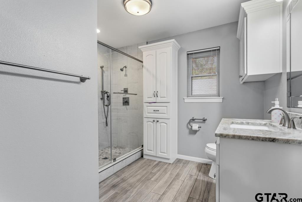 1302 Lake Cross Road Hideaway, TX 75771 - Photo 31 of 31 a bathroom with a sink toilet and shower