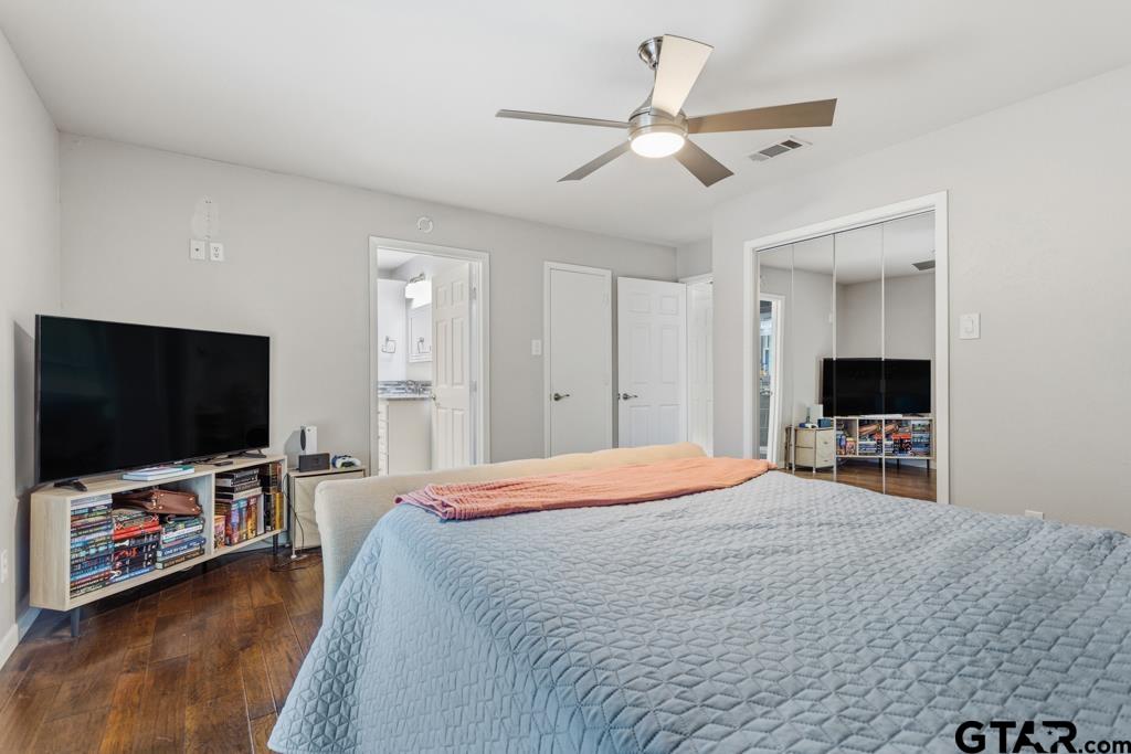 1302 Lake Cross Road Hideaway, TX 75771 - Photo 5 of 31 a bedroom with a bed and a flat screen tv