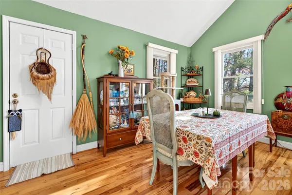 a view of a dining room with furniture and a window
