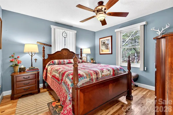 a bed sitting in a bedroom next to a window