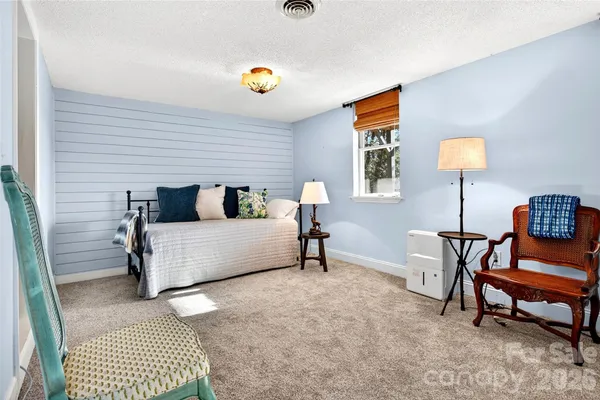 a bedroom with a bed and a lamp