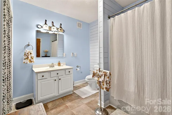 a spacious bathroom with a double vanity sink and a mirror