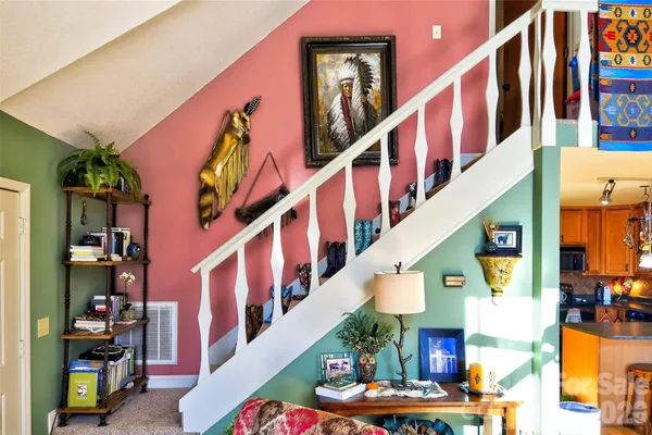 a view of entryway and hall with stairs