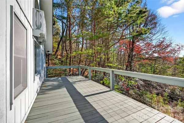 a view of balcony with wooden floor and fence