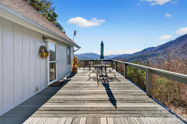 a view of balcony with wooden floor and fence