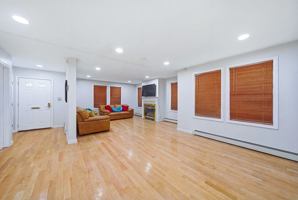 39 Hawthorne Street, Unit 39 Boston, MA 02119 - Photo 3 of 33 a living room with furniture and a window