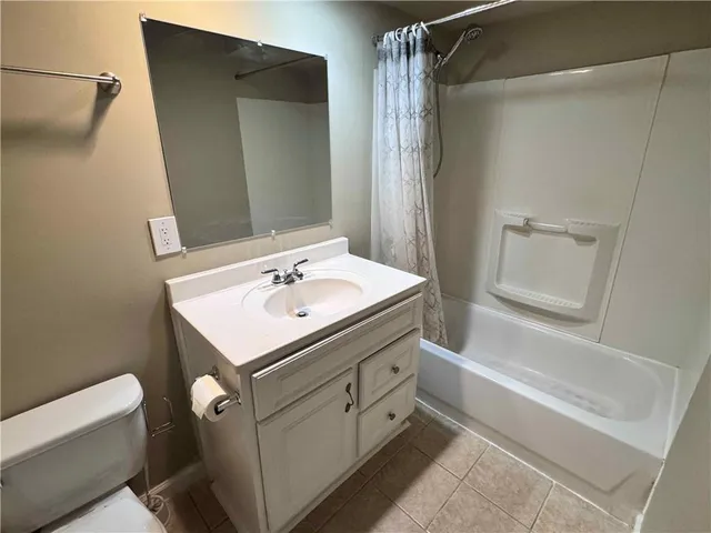 a bathroom with a sink toilet vanity and shower