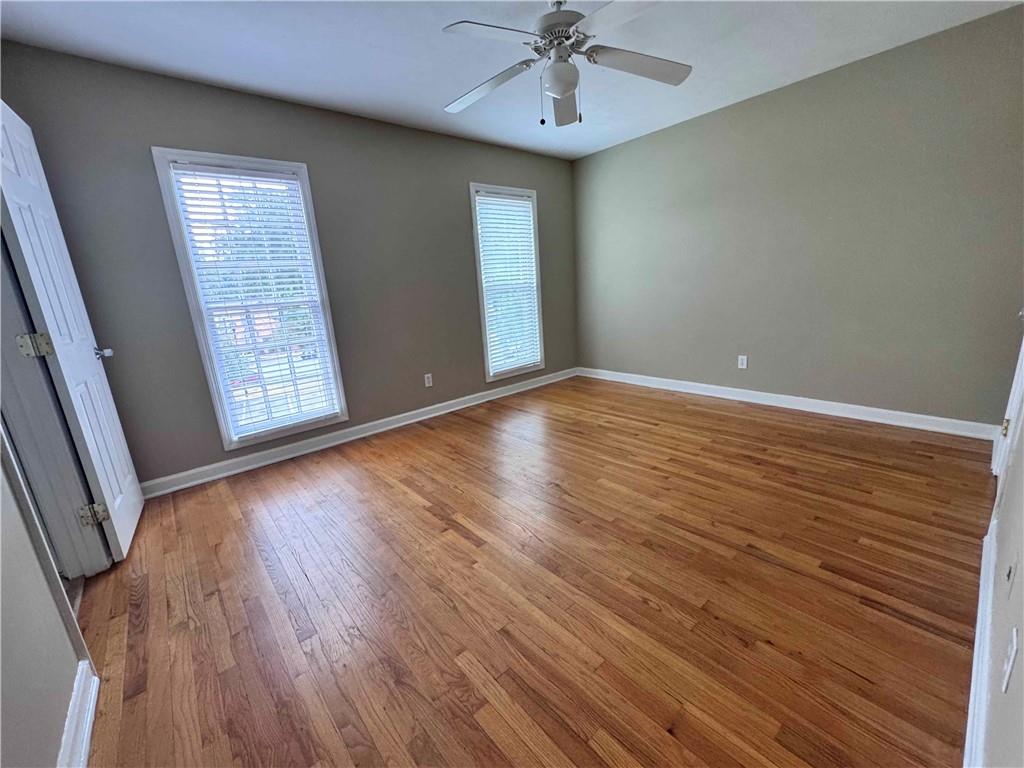 3091 Colonial Way, Unit 3 Atlanta, GA 30341 - Photo 27 of 34 an empty room with wooden floor chandelier fan and windows