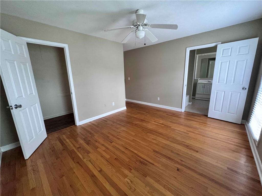 3091 Colonial Way, Unit 3 Atlanta, GA 30341 - Photo 29 of 34 a view of an empty room with wooden floor and a ceiling fan