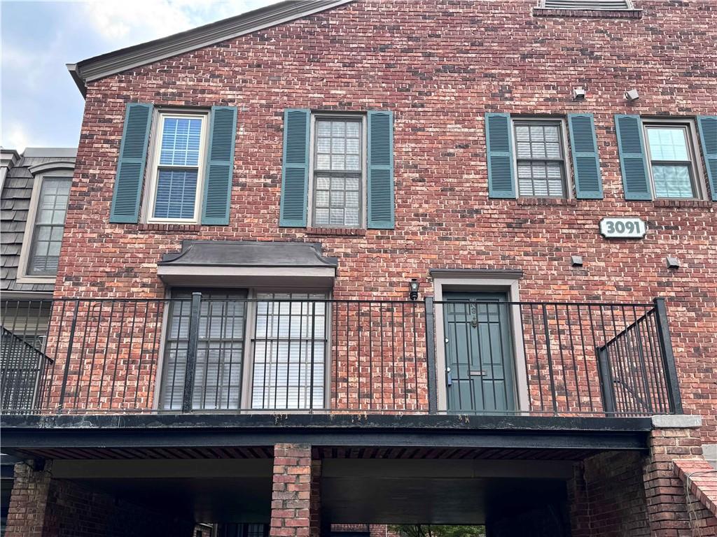 3091 Colonial Way, Unit 3 Atlanta, GA 30341 - Photo 3 of 34 a view of a brick building with many windows