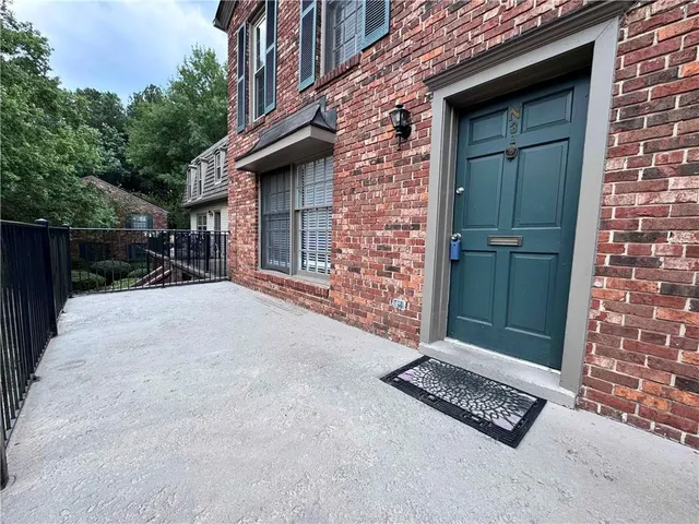 a view of backyard of house and car parked
