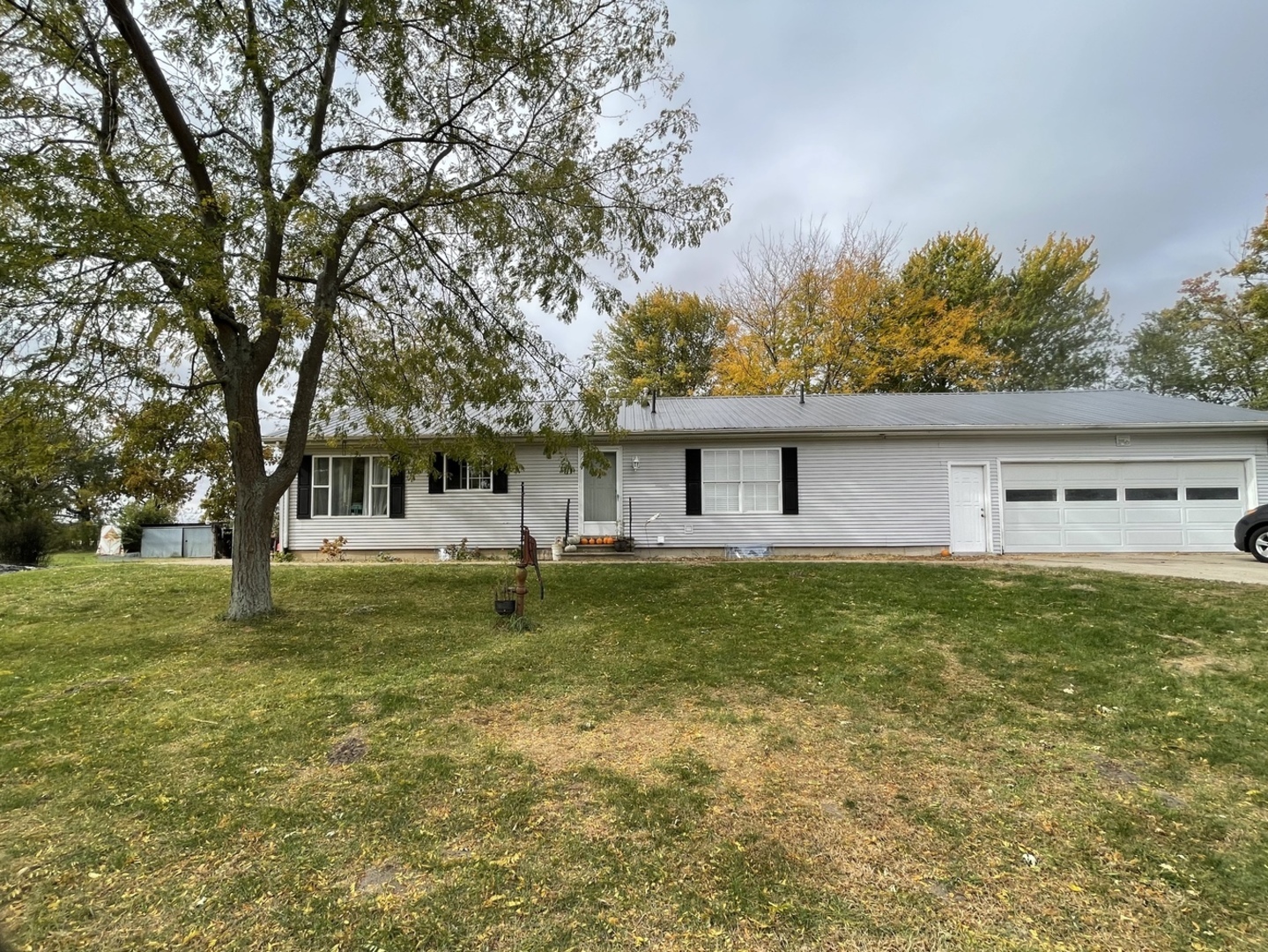 799 Searls Road Amboy, IL 61310 - Photo 1 of 23 a backyard of a house with lots of green space
