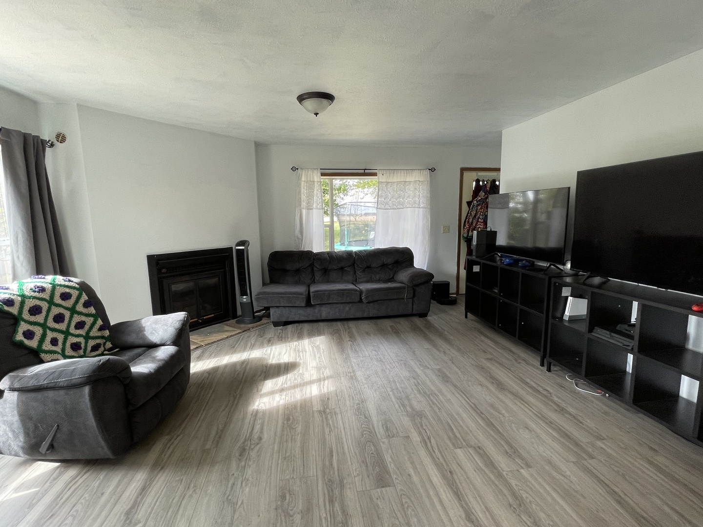 799 Searls Road Amboy, IL 61310 - Photo 13 of 23 a living room with furniture and a flat screen tv