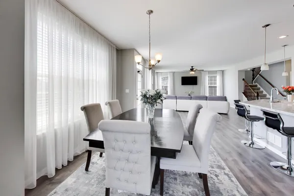 a living room with furniture a flat screen tv and a large window