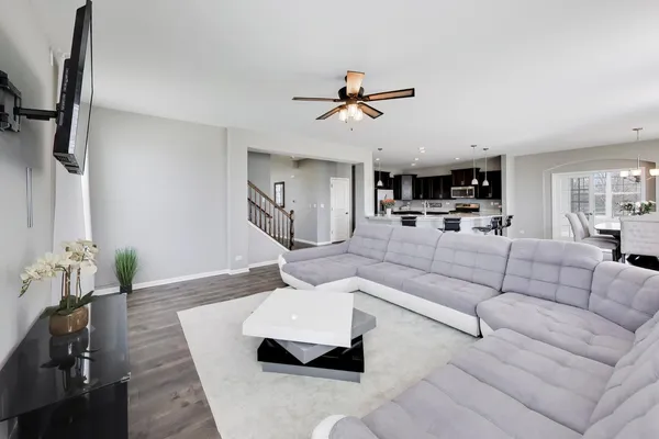 a living room with furniture and a wooden floor