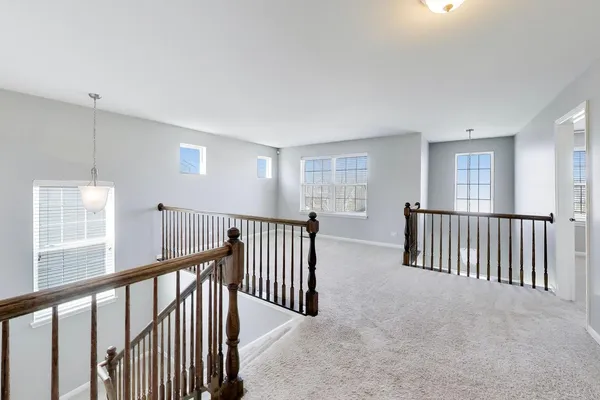 a view of staircase with rug floor