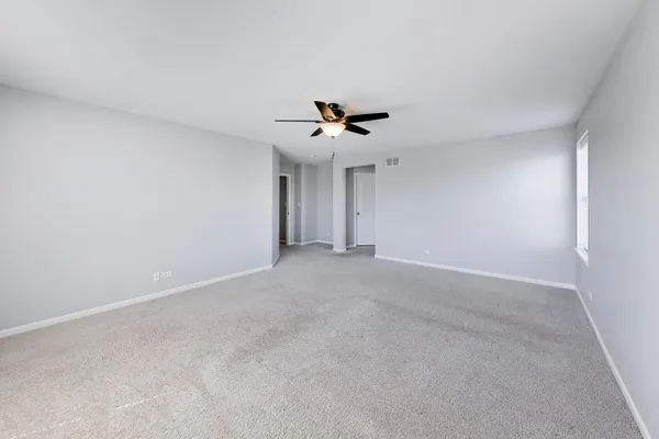 a view of a livingroom with a ceiling fan and a chandelier fan