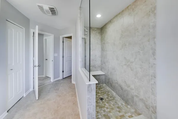 a bathroom with a shower and a sink