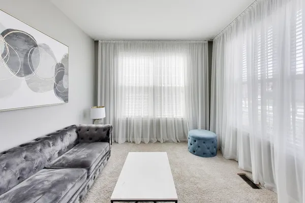 a spacious bedroom with a bed and a couch