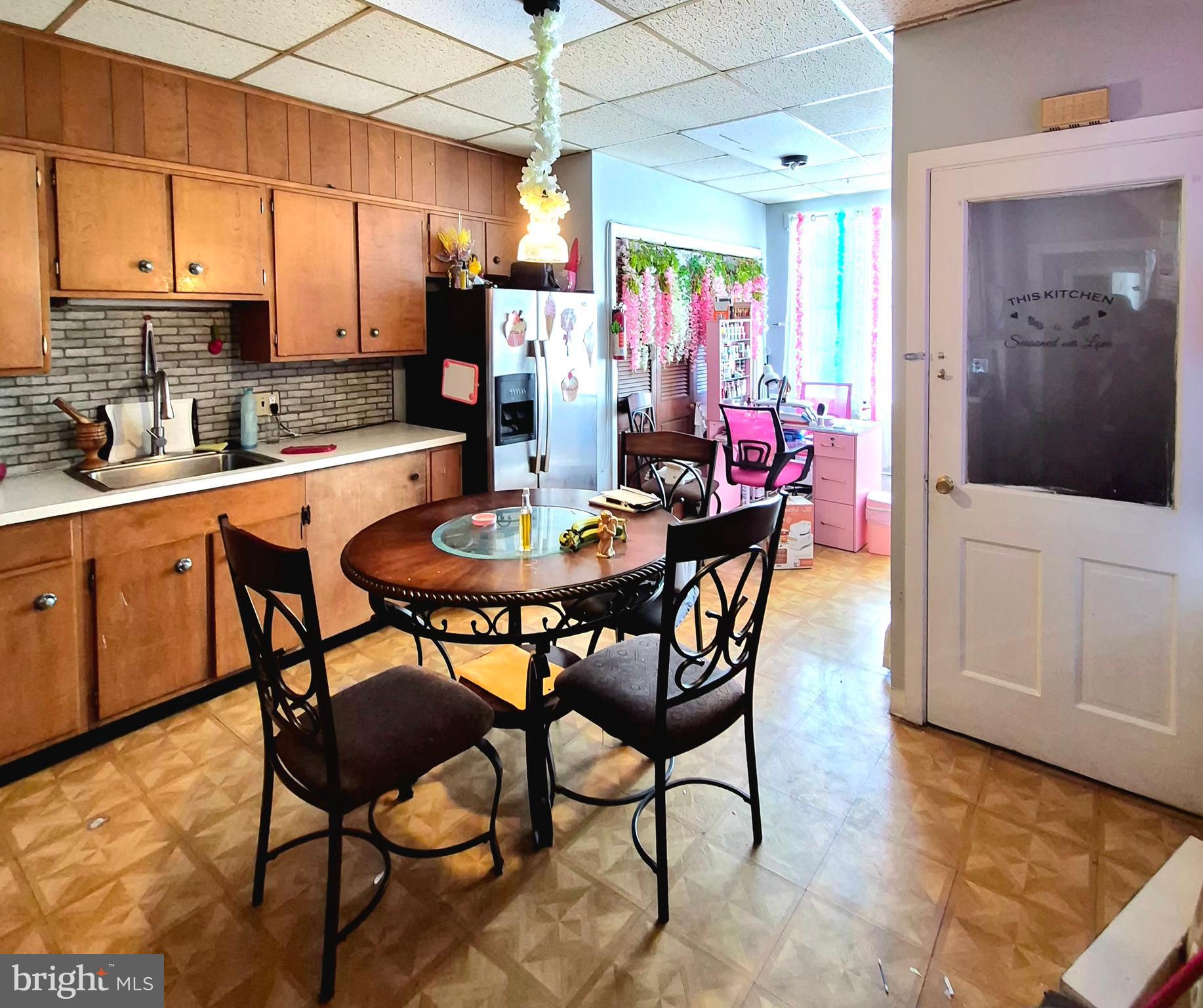 220 North 6th Street Reading, PA 19601 - Photo 21 of 30 a dining room with stainless steel appliances kitchen island granite countertop a table chairs and a refrigerator