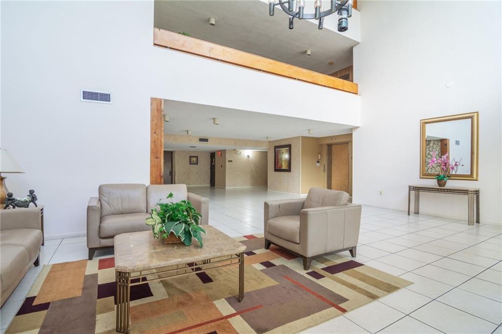 491 Racquet Club Road, Unit 212 Weston, FL 33326 - Photo 26 of 27 a living room with furniture and a table