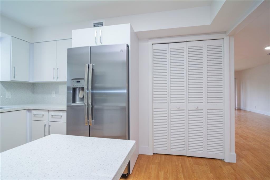 491 Racquet Club Road, Unit 212 Weston, FL 33326 - Photo 6 of 27 a kitchen with stainless steel appliances a refrigerator and cabinets