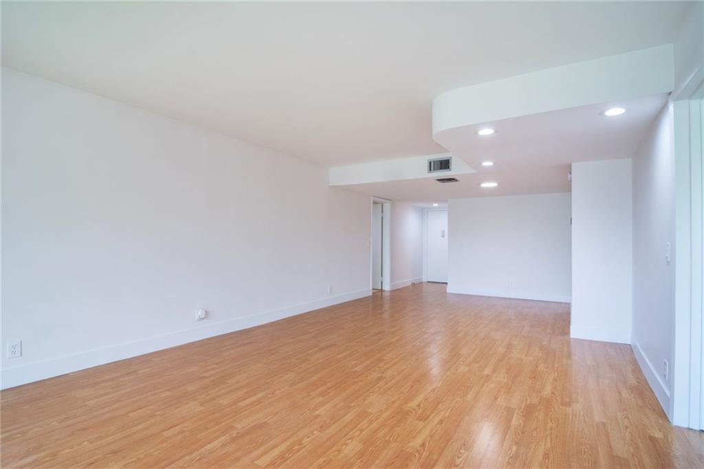 491 Racquet Club Road, Unit 212 Weston, FL 33326 - Photo 10 of 27 a view of an empty room with wooden floor