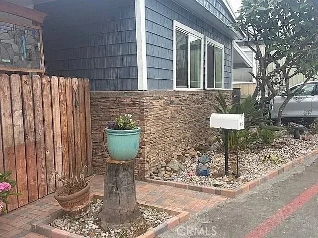a front view of a house with a garden and trees