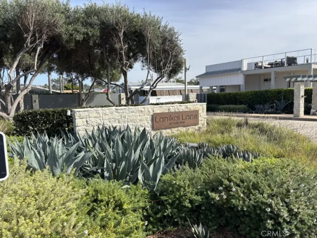 a front view of a house with a flower garden