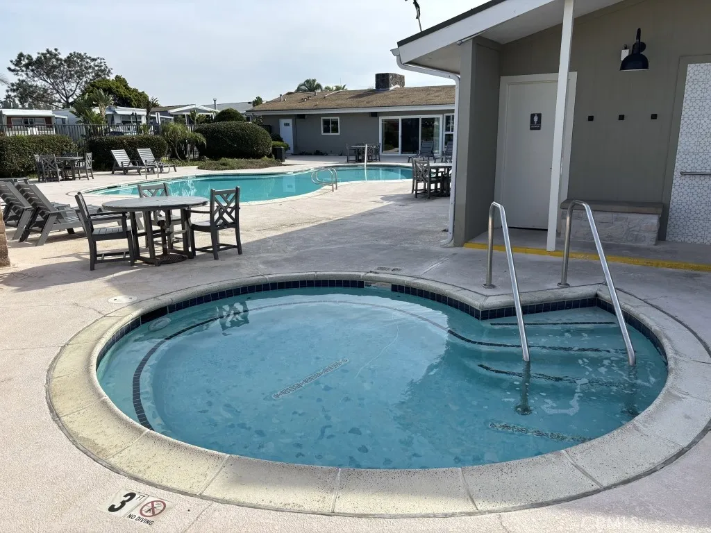 6550 Ponto, Unit 76 Carlsbad, CA 92011 - Photo 6 of 25 a view of a swimming pool with sitting area