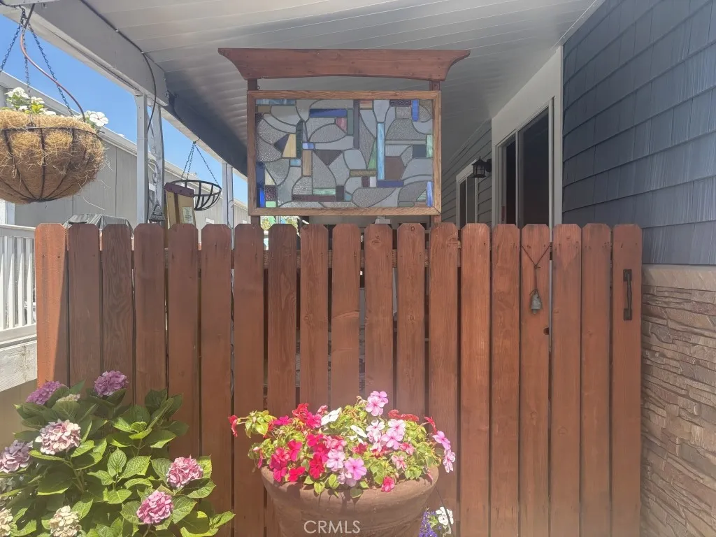 6550 Ponto, Unit 76 Carlsbad, CA 92011 - Photo 7 of 25 a front view of a house with a flower garden