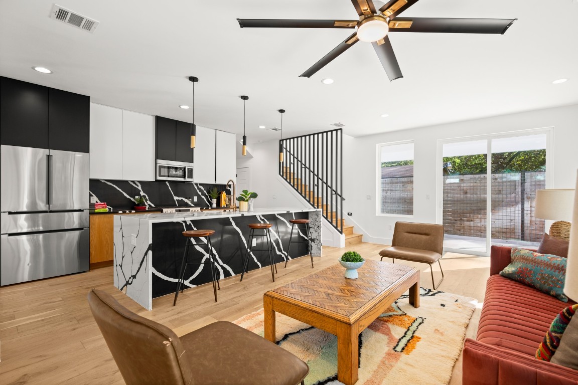 2902 Gonzales Street, Unit 2 Austin, TX 78702 - Photo 11 of 32 Living area with light wood-type flooring, recessed lighting, ceiling fan, and stairway