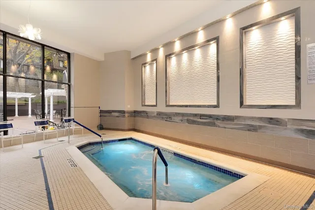 a bathroom with a large tub and sink
