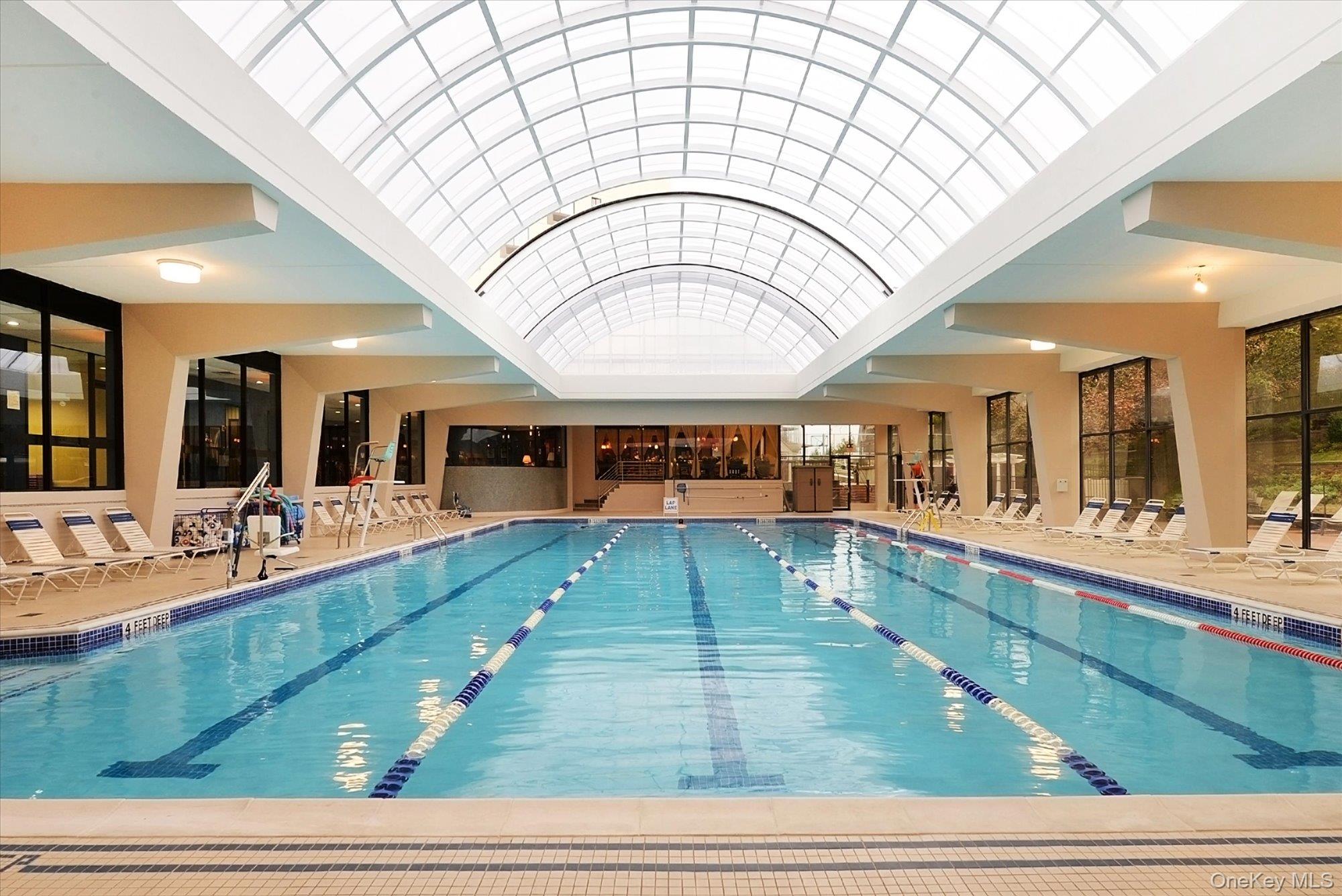 1 Bay Club Drive, Unit 8J Queens, NY 11360 - Photo 14 of 17 a large hall with lots of dining table and sofas