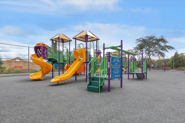 a view of a park with slide and table