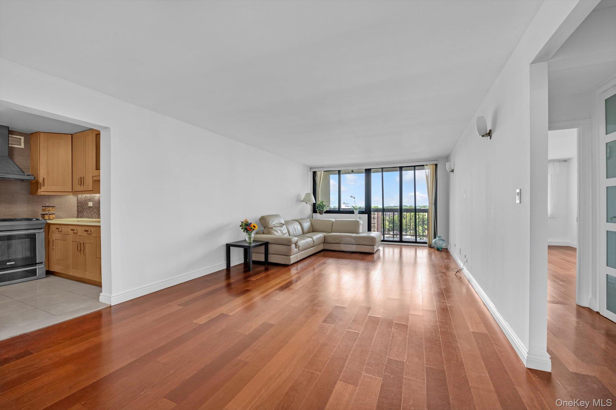 1 Bay Club Drive, Unit 8J Queens, NY 11360 - Photo 3 of 17 a living room with furniture and a wooden floor
