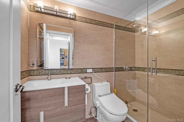 a bathroom with a toilet a sink and shower
