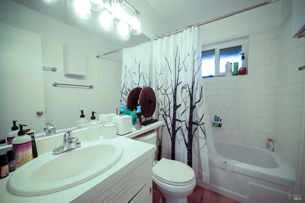 a bathroom with a sink a toilet and bathtub