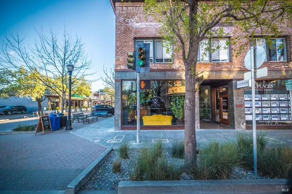 a view of a street with stores