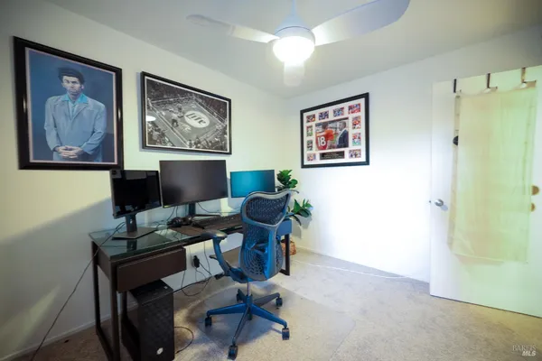 a work room with furniture and paintings on the wall